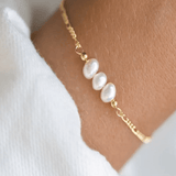 A bracelet with three pearls